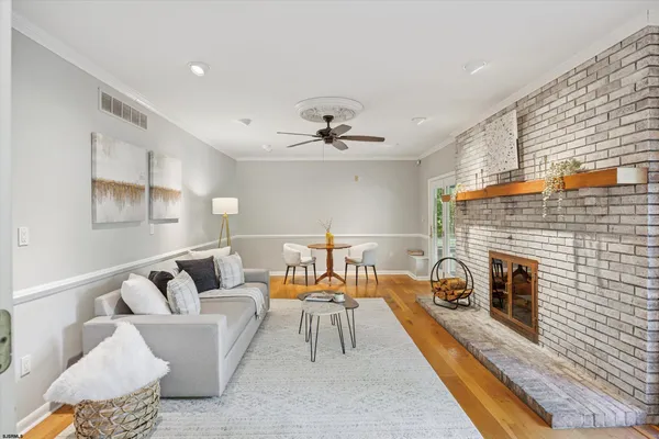 a living room with furniture and a fireplace