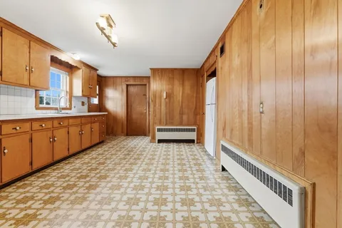 a bathroom with a sink a toilet a mirror and shower