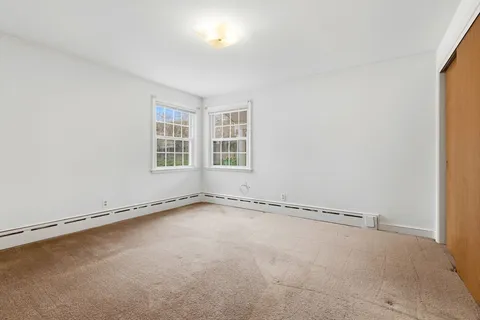 an empty room with a windows