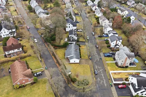 an aerial view of a house with a swimming pool