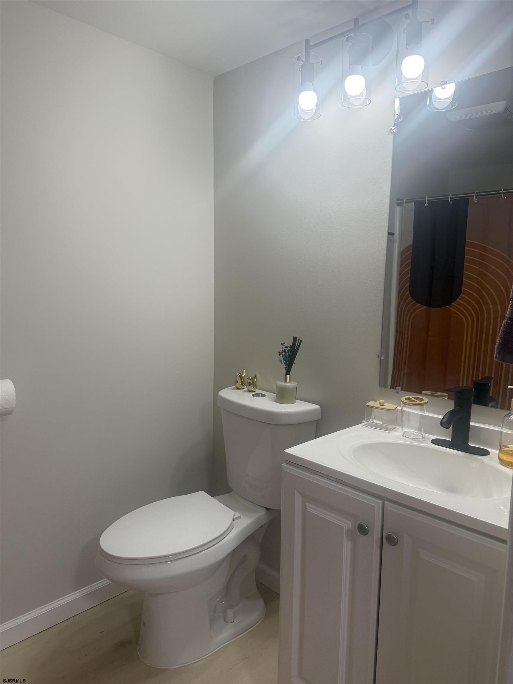 2580 Tilton Road, Unit 112 MODEL Egg Harbor Township, NJ 08234 - Photo 13 of 15 a bathroom with a sink vanity mirror and toilet