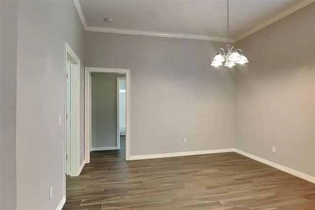 a view of a chandelier fan and wooden floor