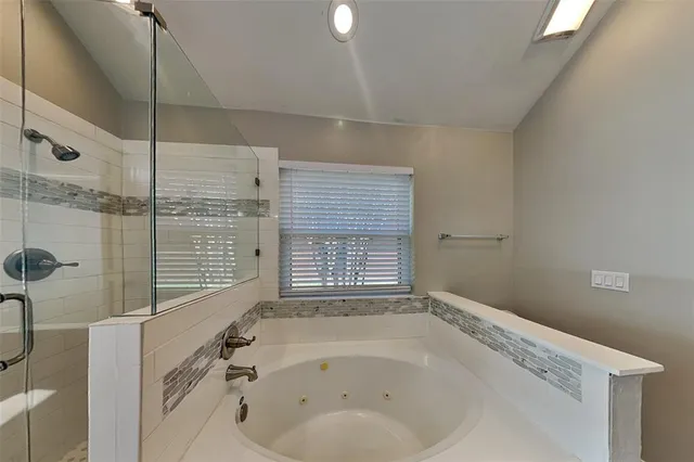 a bathroom with a bathtub and shower