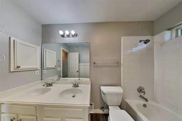a bathroom with a sink and mirror with toilet