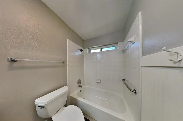 a bathroom with a toilet and a bathtub
