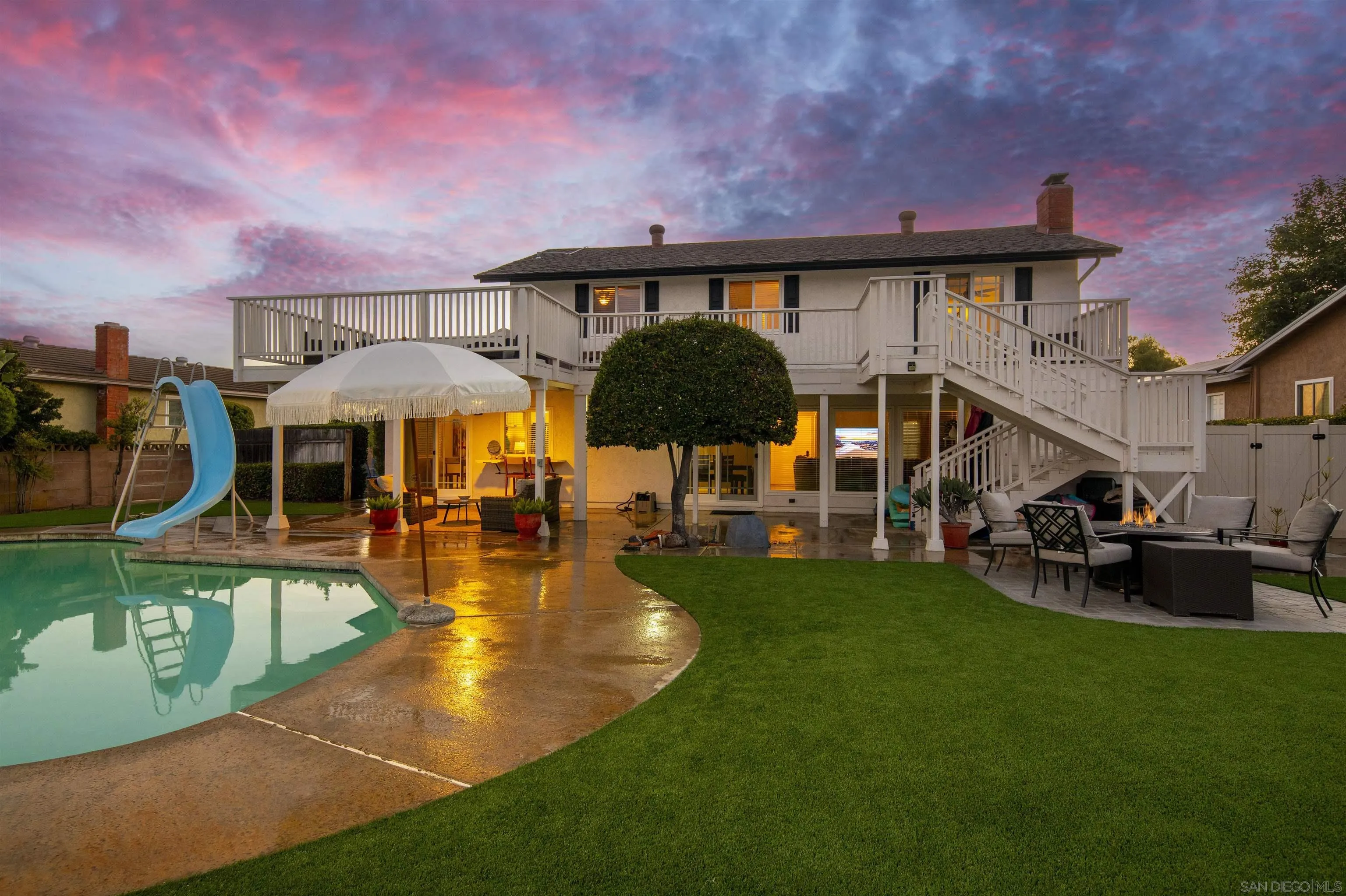 a swimming pool view with a seating space and a garden