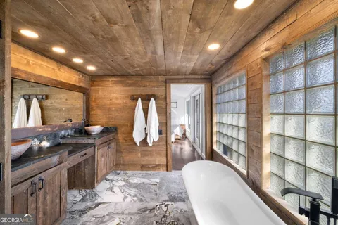 a room with stainless steel appliances kitchen island granite countertop a refrigerator and cabinets
