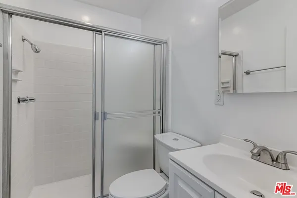 a white toilet sitting next to a bathroom sink