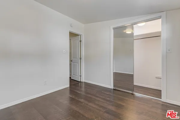 an empty room with wooden floor