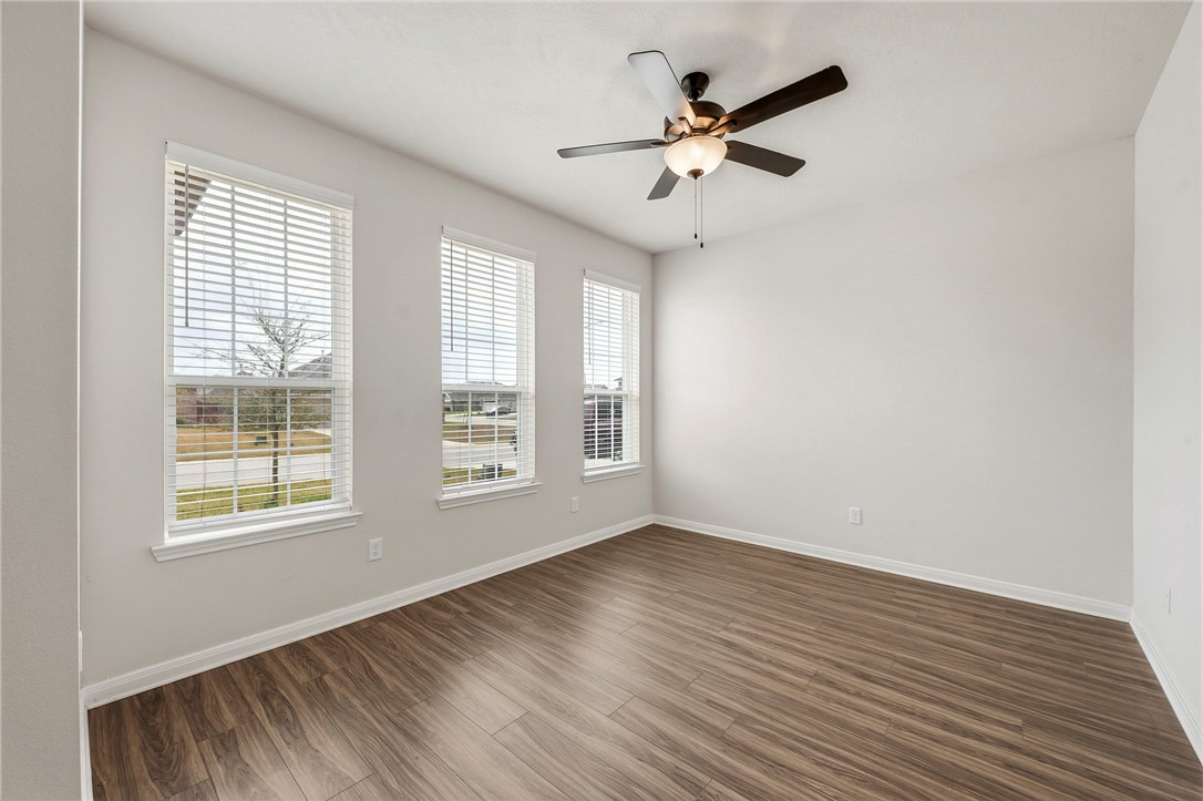 303 Camp Bowie Road Caldwell, TX 77836 - Photo 12 of 25 a view of an empty room with wooden floor and a window