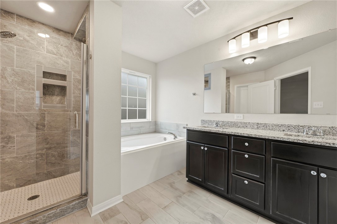 303 Camp Bowie Road Caldwell, TX 77836 - Photo 25 of 25 a bathroom with a bathtub sink vanity and mirror