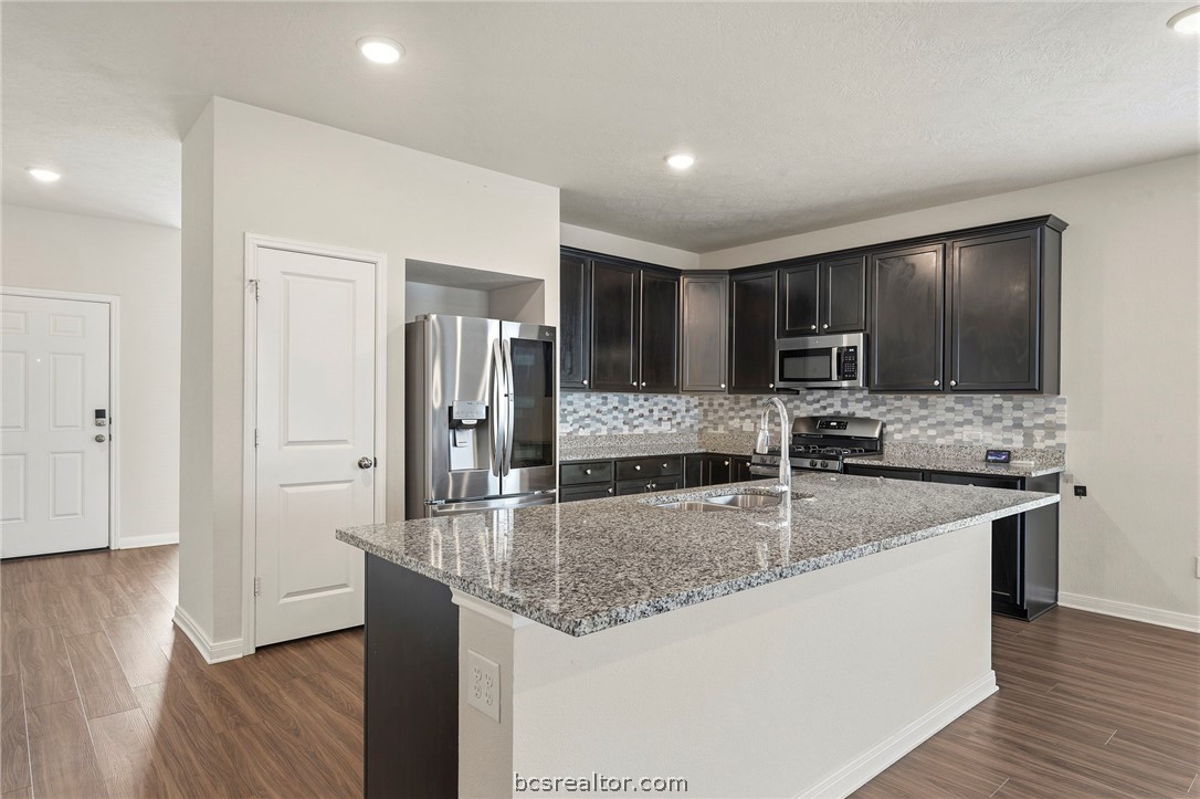 303 Camp Bowie Road Caldwell, TX 77836 - Photo 8 of 25 a kitchen with stainless steel appliances granite countertop a sink refrigerator and microwave