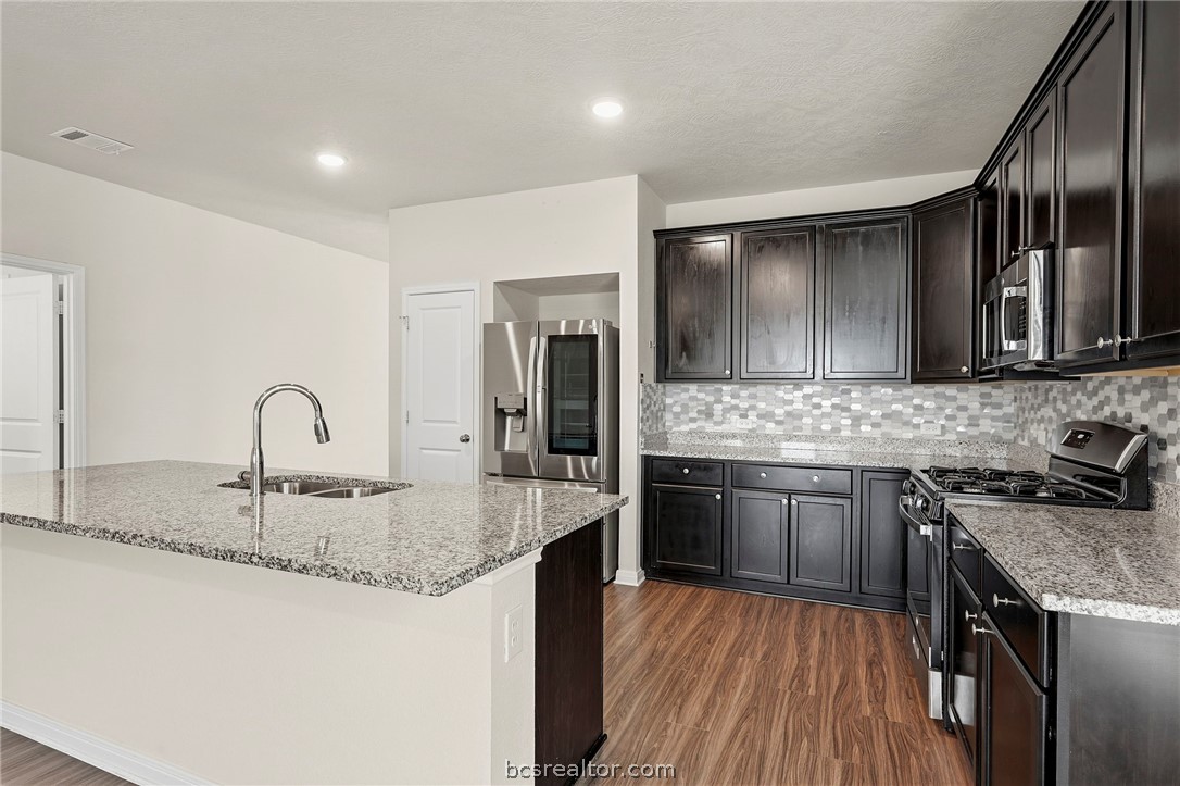303 Camp Bowie Road Caldwell, TX 77836 - Photo 9 of 25 a kitchen with stainless steel appliances granite countertop a sink stove and refrigerator