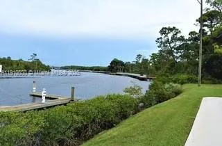 a view of a lake with houses in the back