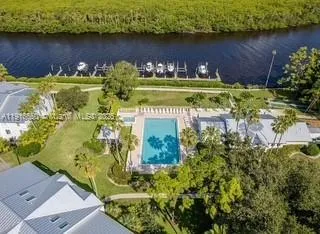 a view of a lake with a yard and large trees