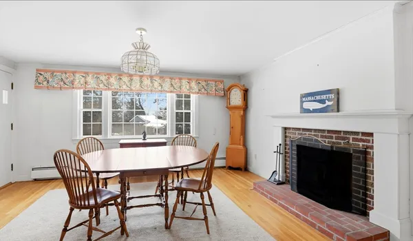 a dining room with furniture a chandelier and wooden floor