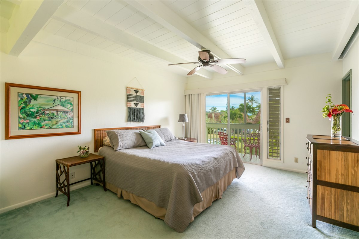 3880 Wyllie Road, Unit 8C Princeville, HI 96722 - Photo 11 of 17 a spacious bedroom with a bed and large window