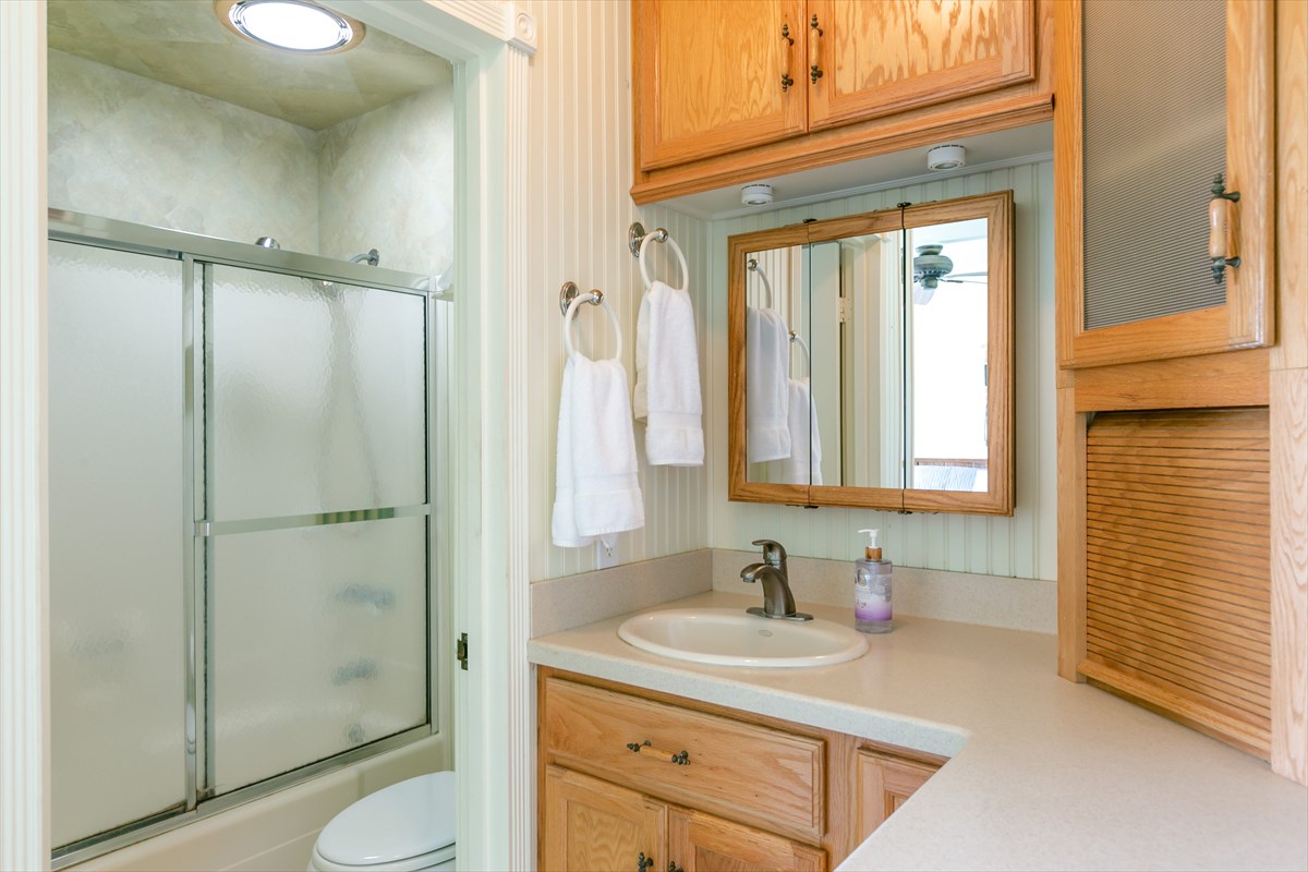 3880 Wyllie Road, Unit 8C Princeville, HI 96722 - Photo 14 of 17 a bathroom with a granite countertop sink toilet and shower