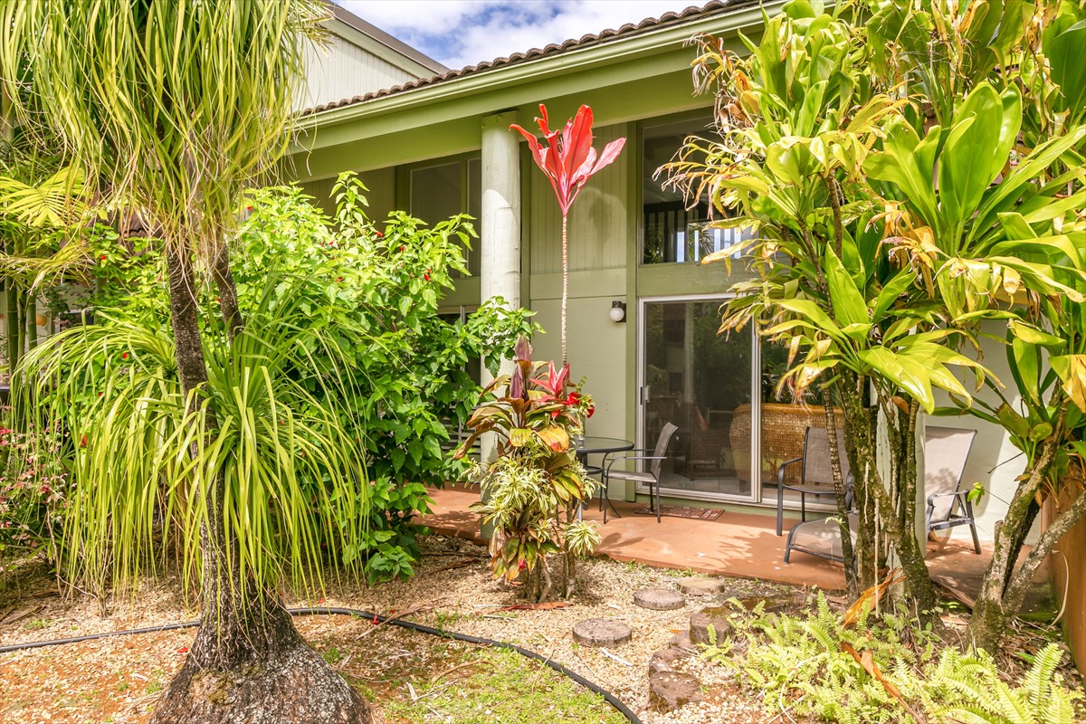 3880 Wyllie Road, Unit 8C Princeville, HI 96722 - Photo 2 of 17 a front view of a house with a yard