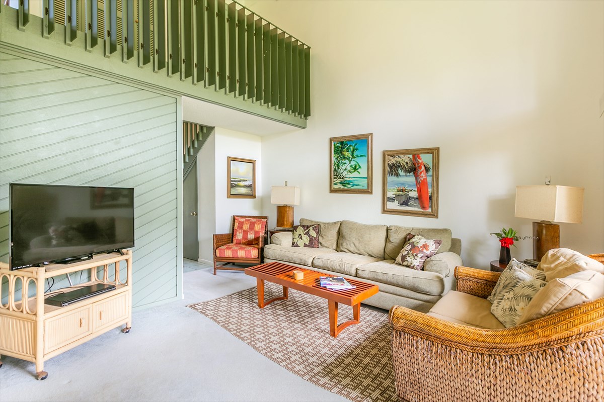 3880 Wyllie Road, Unit 8C Princeville, HI 96722 - Photo 4 of 17 a living room with furniture and a flat screen tv