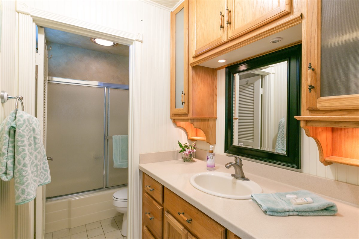 3880 Wyllie Road, Unit 8C Princeville, HI 96722 - Photo 10 of 17 a bathroom with a granite countertop sink and a mirror