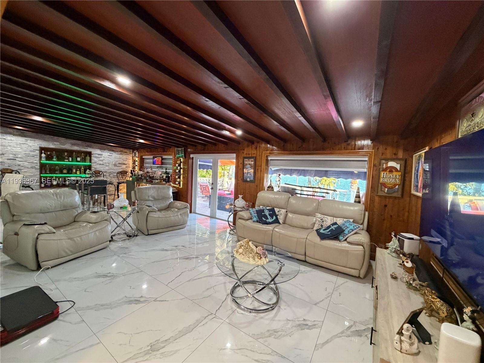 15022 Southwest 67th Lane Miami, FL 33193 - Photo 22 of 34 a living room with furniture a ceiling fan and a rug