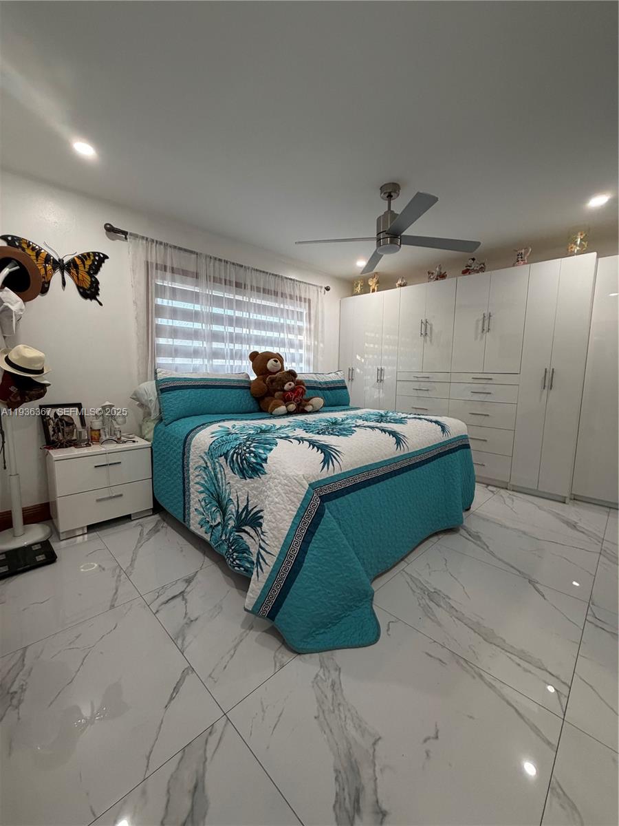 15022 Southwest 67th Lane Miami, FL 33193 - Photo 27 of 34 a bedroom with a bed and a window