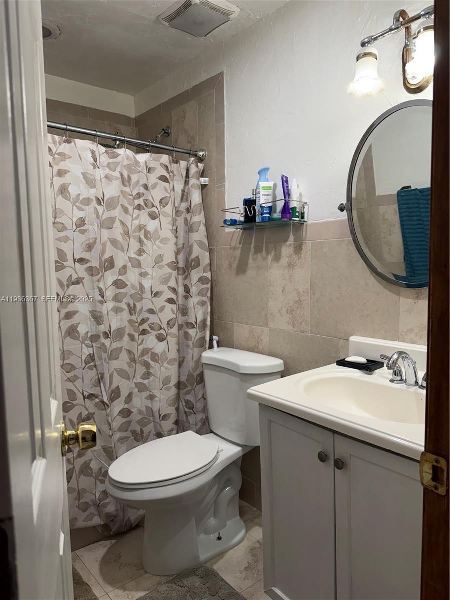 15022 Southwest 67th Lane Miami, FL 33193 - Photo 32 of 34 a bathroom with a sink a toilet and a mirror