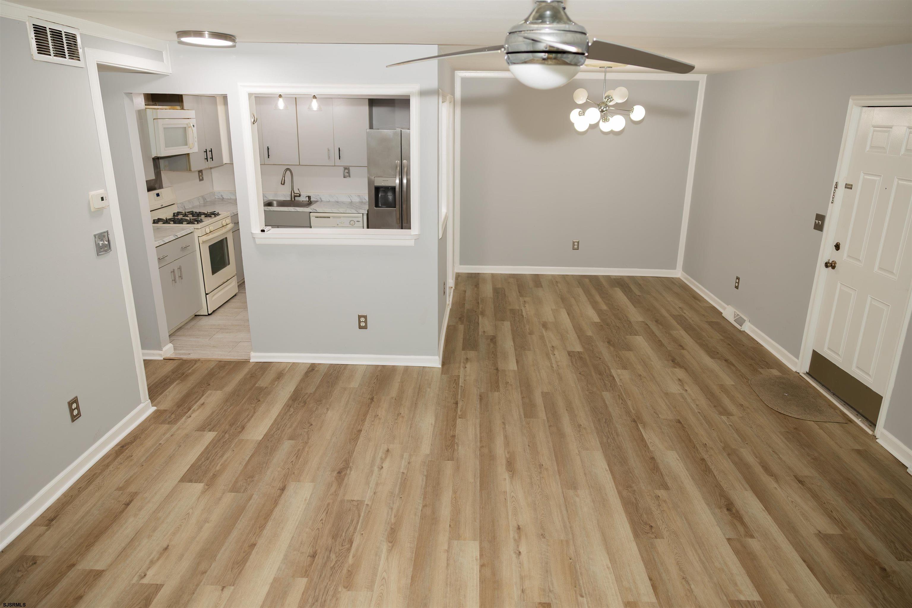 2 Oyster Bay Road, Unit 2D Absecon, NJ 08205 - Photo 20 of 26 a view of a kitchen with wooden floor and windows