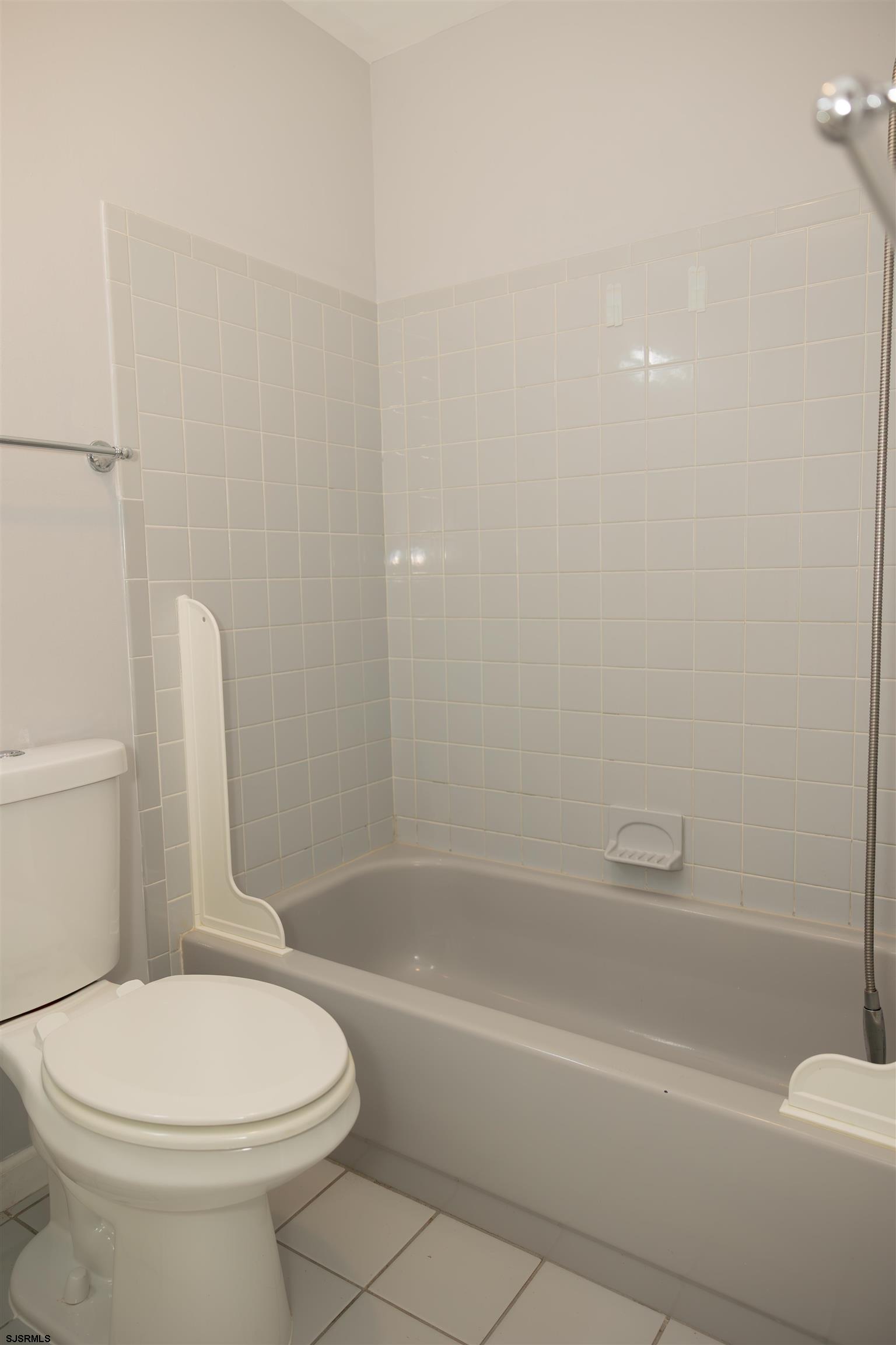 2 Oyster Bay Road, Unit 2D Absecon, NJ 08205 - Photo 22 of 26 a bathroom with a toilet and shower