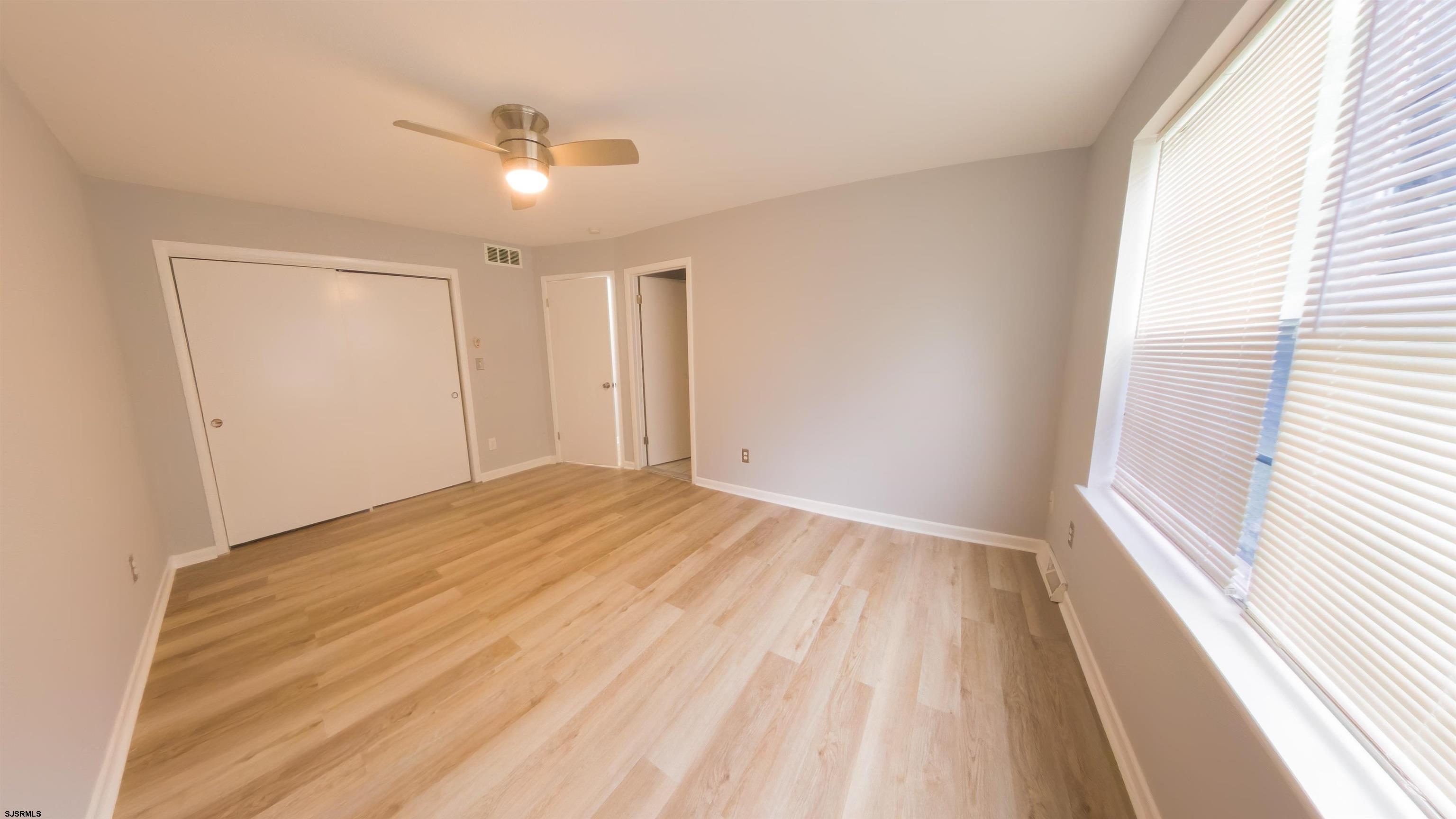 2 Oyster Bay Road, Unit 2D Absecon, NJ 08205 - Photo 24 of 26 a view of empty room with wooden floor and fan