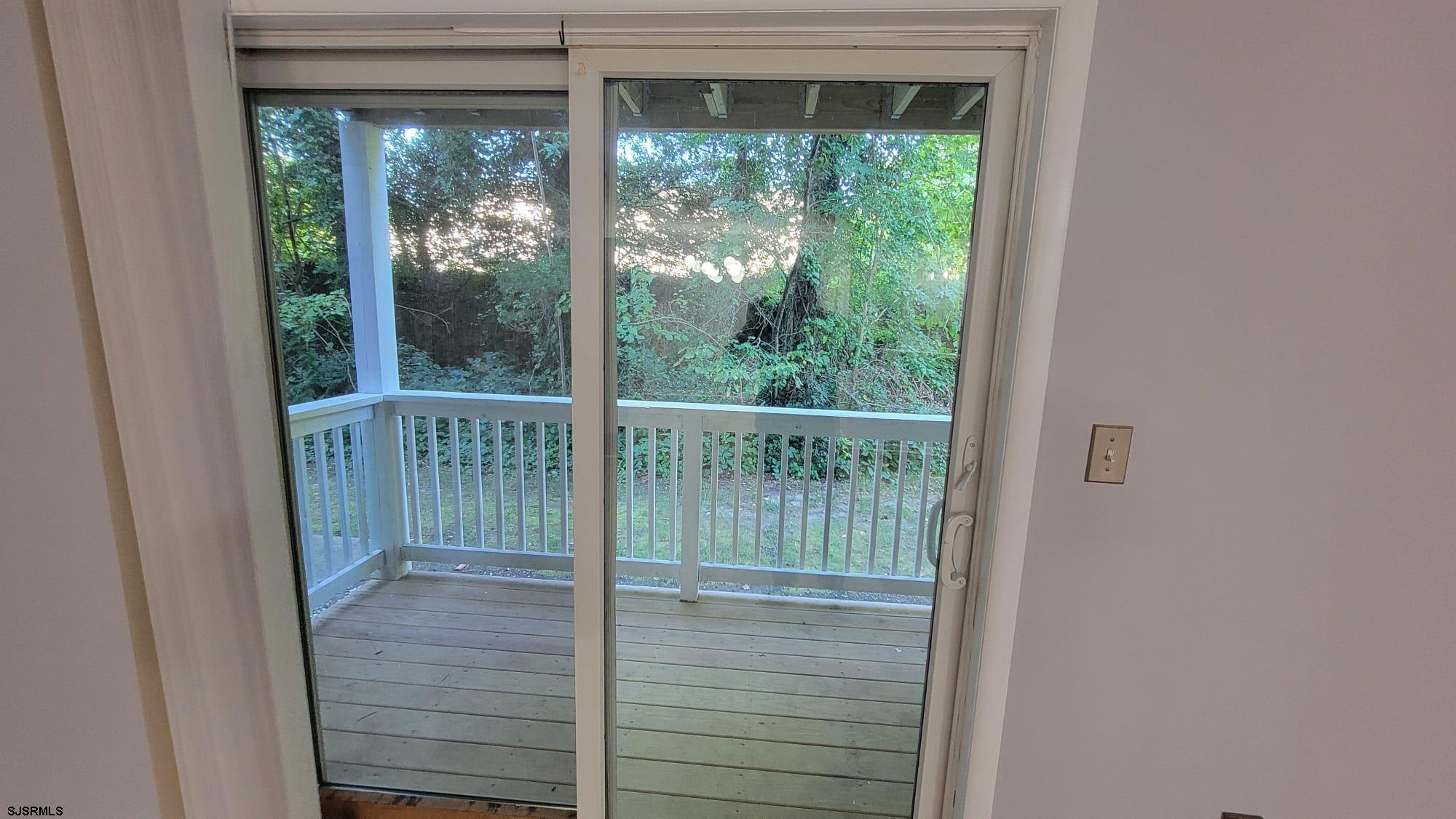 2 Oyster Bay Road, Unit 2D Absecon, NJ 08205 - Photo 25 of 26 a view of a glass door and the balcony