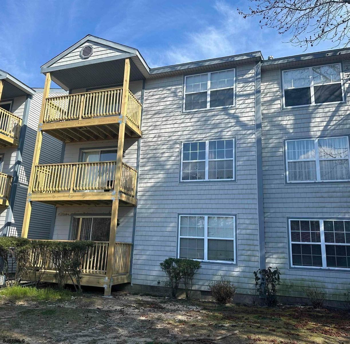2 Oyster Bay Road, Unit 2D Absecon, NJ 08205 - Photo 26 of 26 a front view of a house with a yard