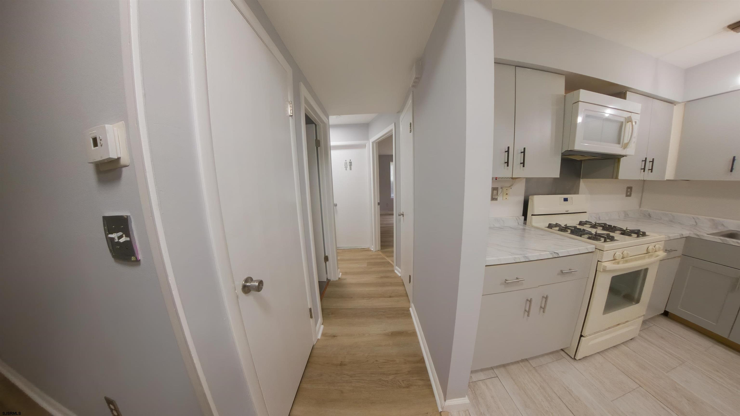 2 Oyster Bay Road, Unit 2D Absecon, NJ 08205 - Photo 5 of 26 a view of a kitchen from the hallway