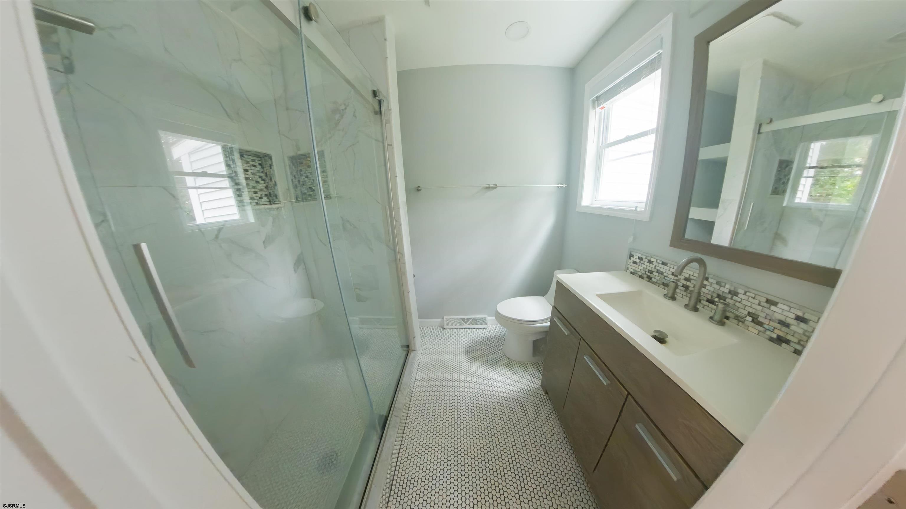 2 Oyster Bay Road, Unit 2D Absecon, NJ 08205 - Photo 8 of 26 a bathroom with a sink a toilet and shower