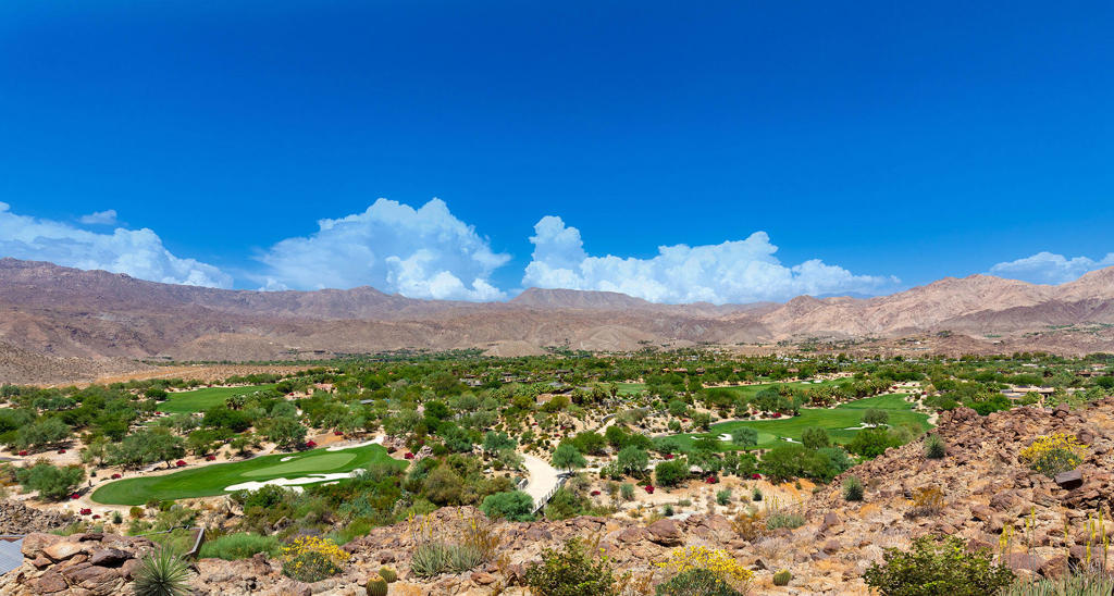 702 Summit Palm Desert, CA 92260 - Photo 2 of 8 a view of a lush green hillside and a houses