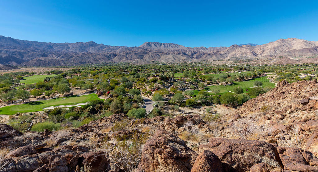 702 Summit Palm Desert, CA 92260 - Photo 6 of 8 a view of a lush green hillside and a houses