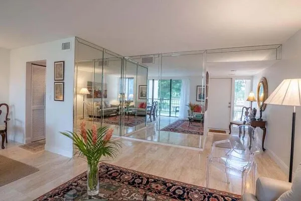 a living room with furniture dining table and a large window