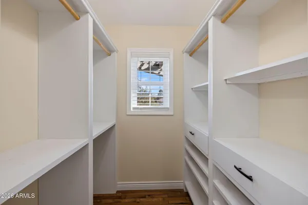 a view of a porch with a floor to ceiling window and wooden floor