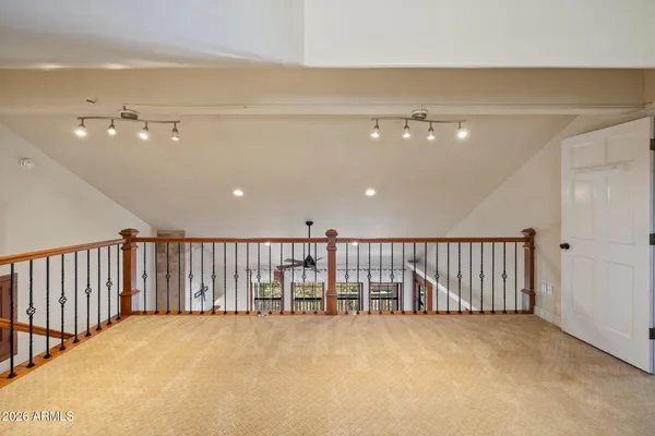 a view of a hallway with wooden shelves
