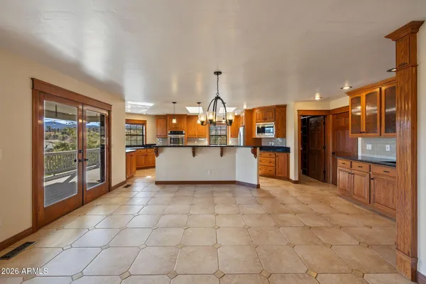 a large kitchen with kitchen island a sink stainless steel appliances and cabinets
