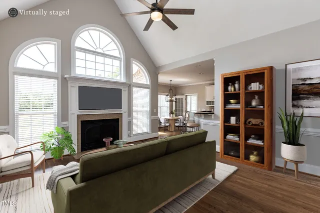a living room with furniture fireplace and wooden floor