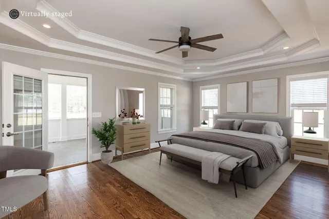 a spacious bedroom with a large bed and a chandelier