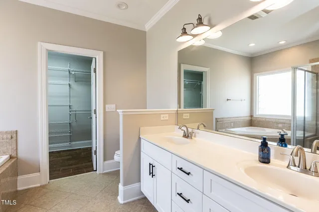 a bathroom with a sink double vanity and a mirror