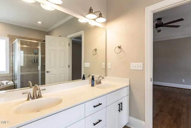 a bathroom with a sink double vanity and a mirror