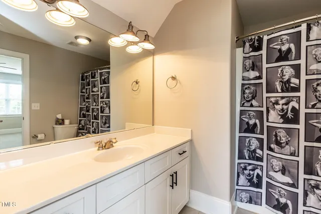 a bathroom with a double vanity sink and a mirror