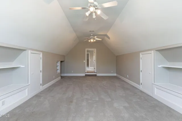 wooden floor in an empty room with a chandelier fan