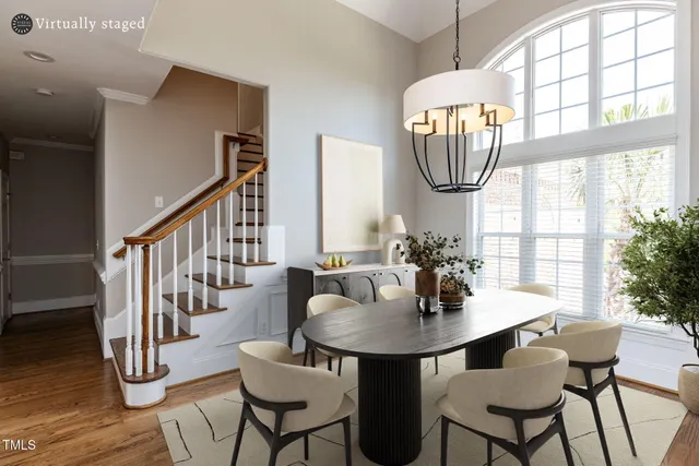 a view of a dining room with furniture a chandelier and wooden floor