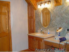 920 Line Rd Lake Lake Ariel, PA 18436 - Photo 4 of 6 a bathroom with a sink and a mirror