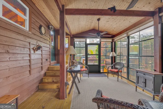 a dining room with wooden floor and furniture